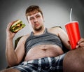 Fat man eating hamburger Royalty Free Stock Photo