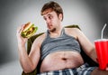 Fat man eating hamburger Royalty Free Stock Photo