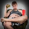 Fat man eating hamburger Royalty Free Stock Photo