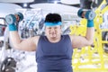 Fat man exercise in fitness center 1 Royalty Free Stock Photo