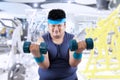 Fat man exercise in fitness center 2 Royalty Free Stock Photo