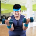 Fat man exercise in fitness center 3 Royalty Free Stock Photo