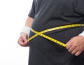 Fat man holding a measurement tape for check out his body isolated on white background. Royalty Free Stock Photo