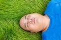 Fat Man Lying on the Green Grass to Relax Royalty Free Stock Photo