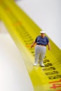 Fat man on a measurer - miniature Royalty Free Stock Photo