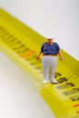 Fat man on a measurer - miniature Royalty Free Stock Photo