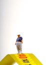 Fat man on a measurer - miniature Royalty Free Stock Photo