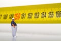 Fat man on a measurer - miniature Royalty Free Stock Photo