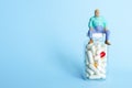 Fat man on medicine bottle with obesity pills and capsules. healthcare of overweight old senior pensioner. pharmaceutical drugs pr