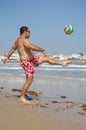 Fat man playing with a ball on the beach Royalty Free Stock Photo