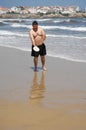 Fat man playing beach tennis on the beach Royalty Free Stock Photo