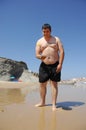 Fat man playing beach tennis on the beach Royalty Free Stock Photo