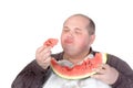 Fat man savouring a slice of watermelon Royalty Free Stock Photo