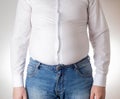 A fat man in a small, tight white shirt. Uncomfortable clothing concept, obesity. Slimming Royalty Free Stock Photo