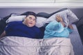 Fat man snoring while sleeping next to his wife Royalty Free Stock Photo