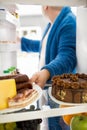 Fat man take plate full of hard food from fridge Royalty Free Stock Photo