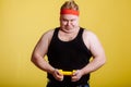 Fat man try to lift small yellow dambbell Royalty Free Stock Photo