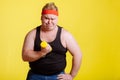 Fat man try to lift small yellow dambbell Royalty Free Stock Photo