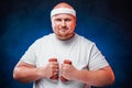 Fat man with two dumbbells in each hand Royalty Free Stock Photo