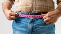 a fat man is using Waist measuring tape to measure his waist, overweight concept Royalty Free Stock Photo