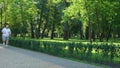 Fat man vigorously jogging in park, persistent in losing weight, motivated