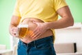 The fat obese man holding beer in dieting concept Royalty Free Stock Photo