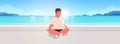 Fat obese man sitting lotus pose on sea beach overweight guy relaxing summer vacation concept seaside ocean beautiful Royalty Free Stock Photo