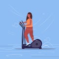 Fat obese woman working on elliptical trainer overweight african american girl doing spinning exercises cardio training Royalty Free Stock Photo