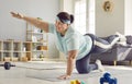Fat overweight funny woman wearing sportswear doing sport fit exercise on the floor at home. Royalty Free Stock Photo