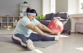 Fat overweight funny woman wearing sportswear doing stretching exercise on the floor at home. Royalty Free Stock Photo