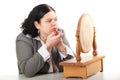 Fat, overweight woman applying lipstick Royalty Free Stock Photo