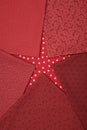 Fat quarters of fabrics red colors lying in the shape like a star on red fabric with white stars pattern