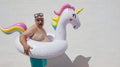 Fat ridiculous man with an unicorn float