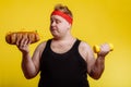 Fat man choise between sport and fastfood Royalty Free Stock Photo