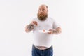 Fat surprised guy eats healthy food Royalty Free Stock Photo