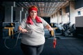 Fat sweaty woman, fitness exercise with rope