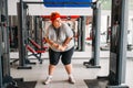 Fat sweaty woman using exercise machine in gym Royalty Free Stock Photo