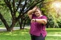 Fat woman asian checking time or heart rate from smart watch.