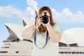 Fat woman with digital camera in Sydney