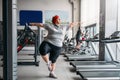 Fat woman doing balance exercise in gym