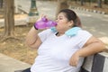 Fat woman drinks water after doing a workout Royalty Free Stock Photo