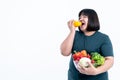 fat woman eating and holding glass bowl  contains fruit and fresh vegetables Royalty Free Stock Photo