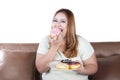 Fat woman eats donuts Royalty Free Stock Photo