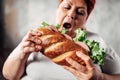 Fat woman eats sandwich, overweight and bulimic Royalty Free Stock Photo