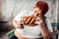 Fat woman eats sandwich, overweight and bulimic Royalty Free Stock Photo