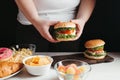 Fat woman fighting the temptation to eat junk food Royalty Free Stock Photo