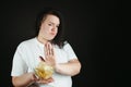Fat woman fighting the temptation to eat junk food Royalty Free Stock Photo