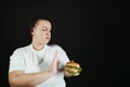 Fat woman fighting the temptation to eat junk food Royalty Free Stock Photo