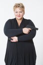 Fat woman with a gun. in a black dress Royalty Free Stock Photo