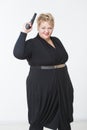 Fat woman with a gun. in a black dress Royalty Free Stock Photo